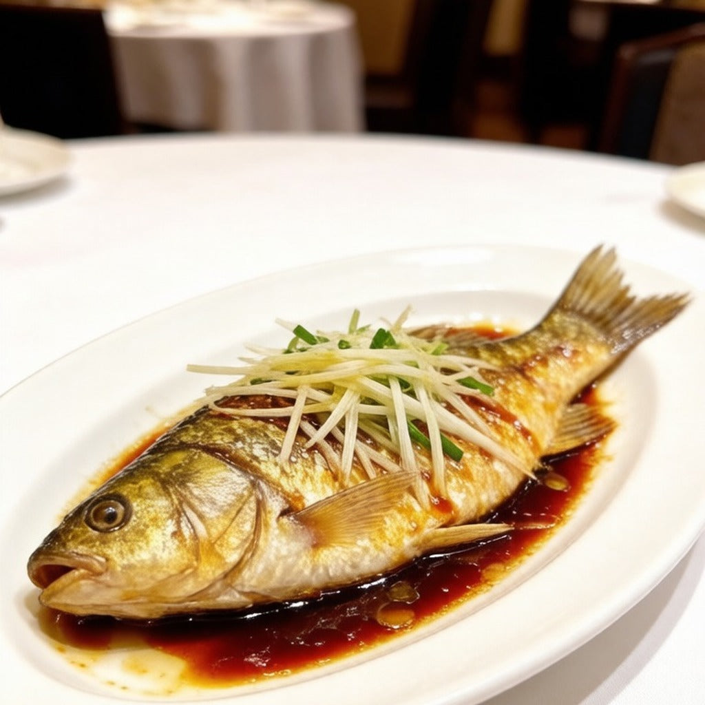 Steamed whole crucian carp topped with shredded scallion and ginger in soy sauce